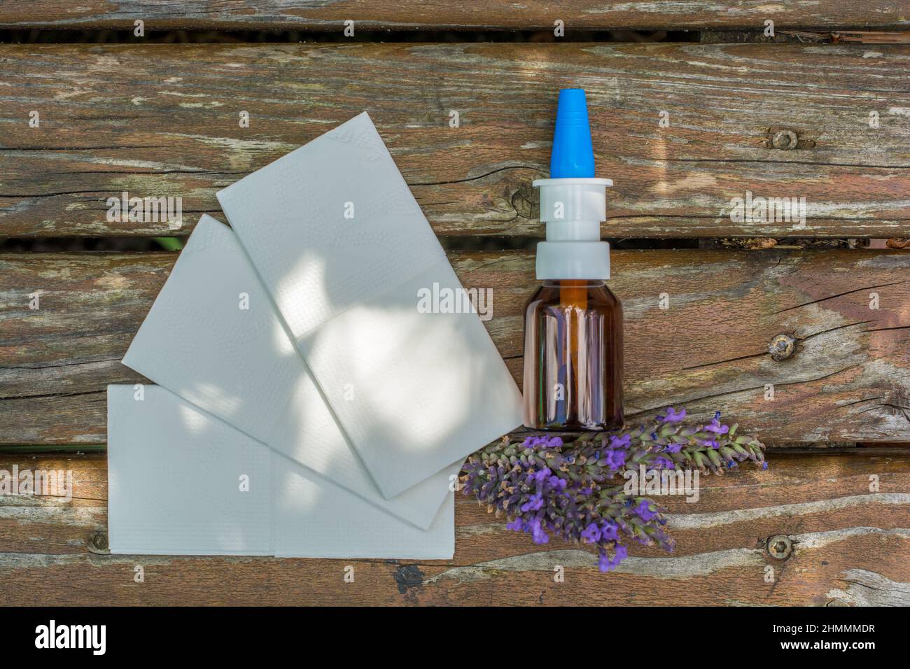 Lavender, handkerchiefs and nasal spray for immediate help with cold as a wooden background photographed from above Stock Photo