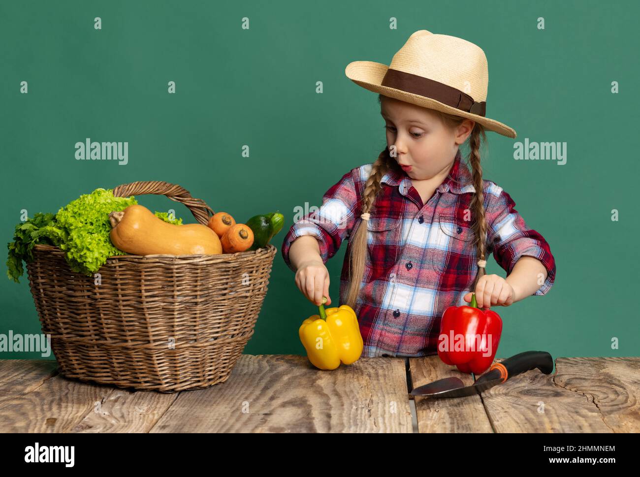 Funny little girl, cheerful kid in image of farmer, gardener having fun ...