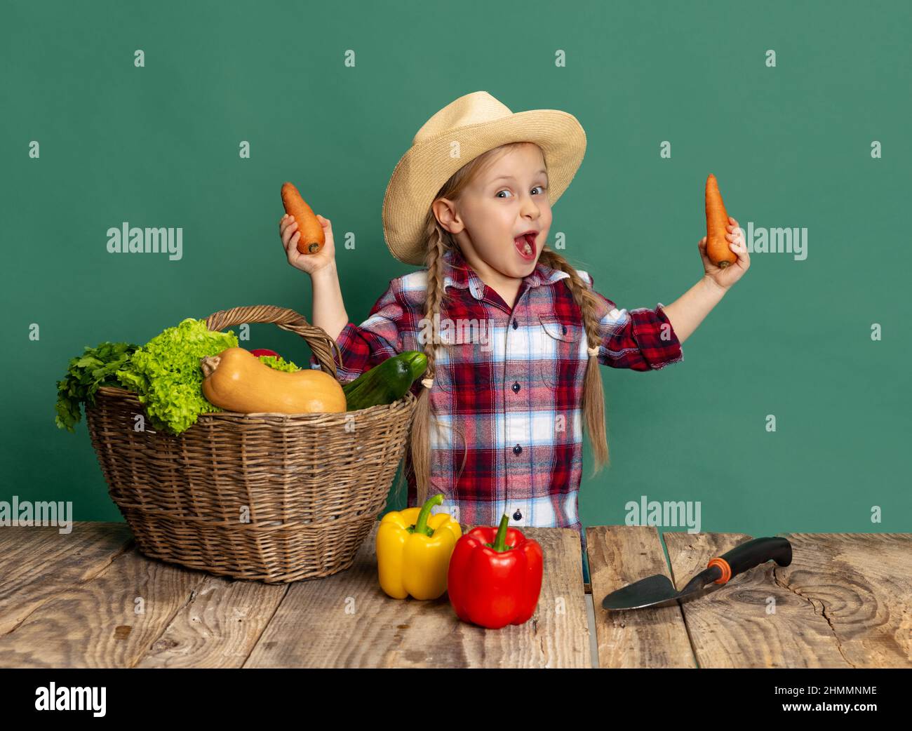 Beautiful little girl, cheerful kid in image of farmer, gardener ...
