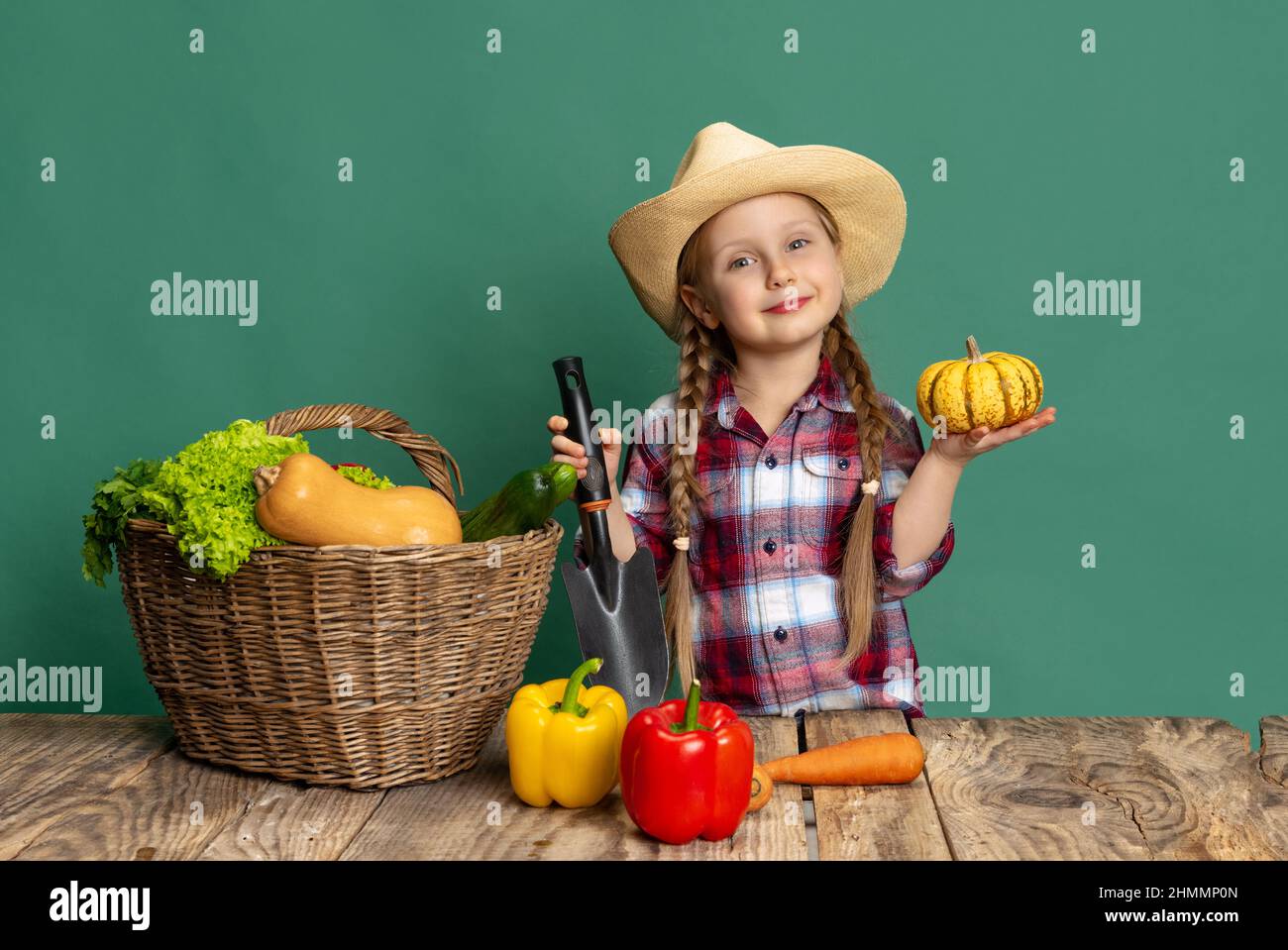 Beautiful little girl, cheerful kid in image of farmer, gardener ...