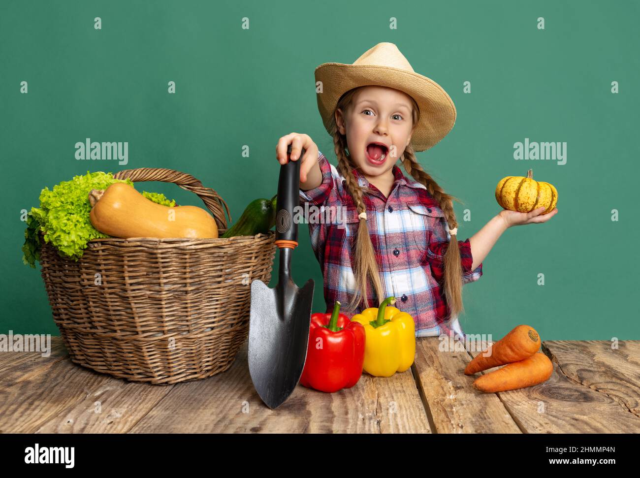 Emotional little girl, cheerful kid in image of farmer, gardener having ...