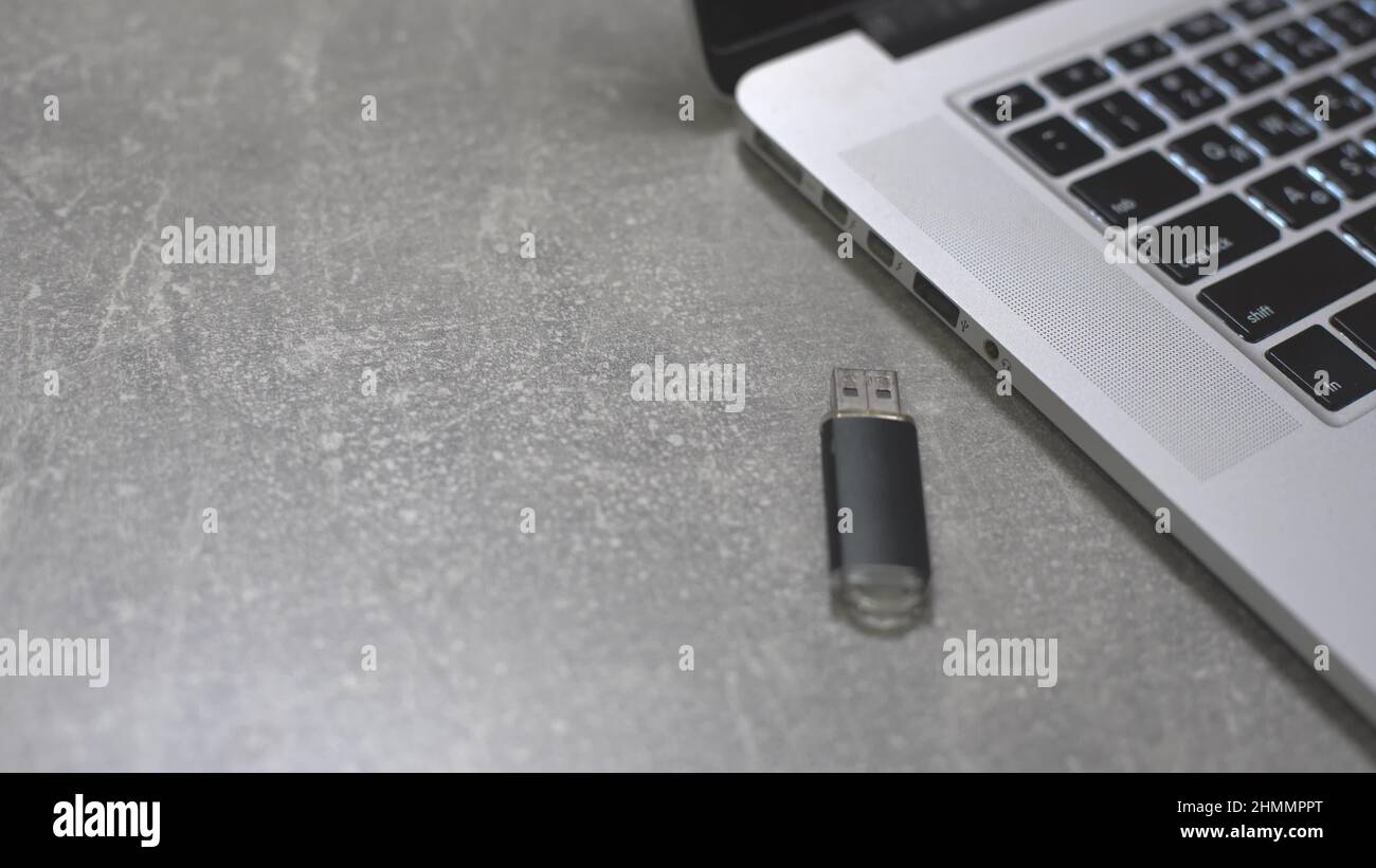 Connect a usb flash drive key to the port of a laptop pc computer Stock ...