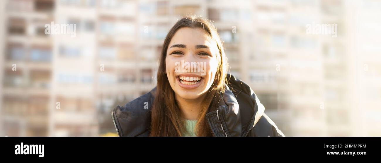 Young woman expressing happiness on a sunny spring day Stock Photo