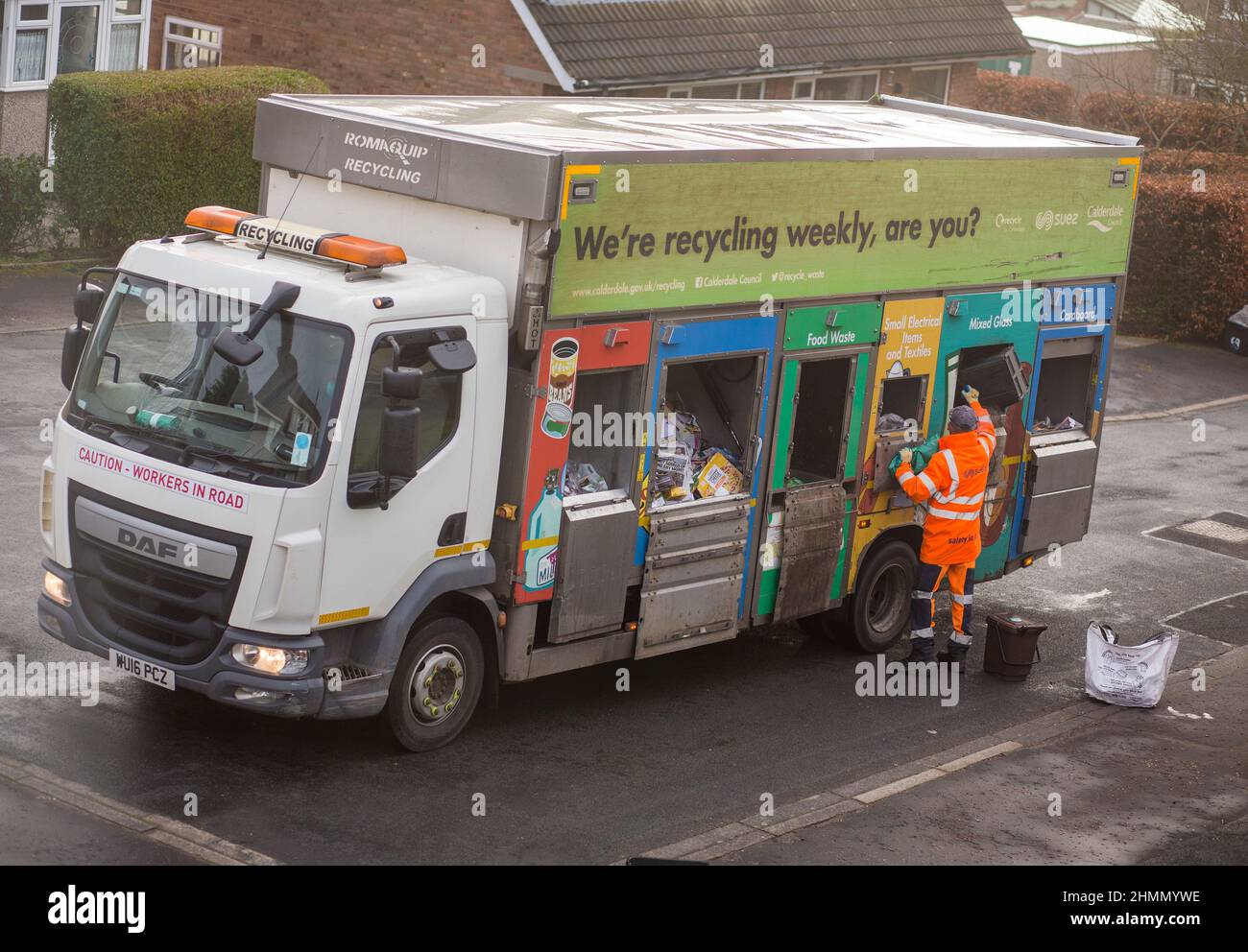 A household recycling waste lorry collects rubbish from homes in Northowram, Halifax, West Yorkshire, UK. Stock Photo