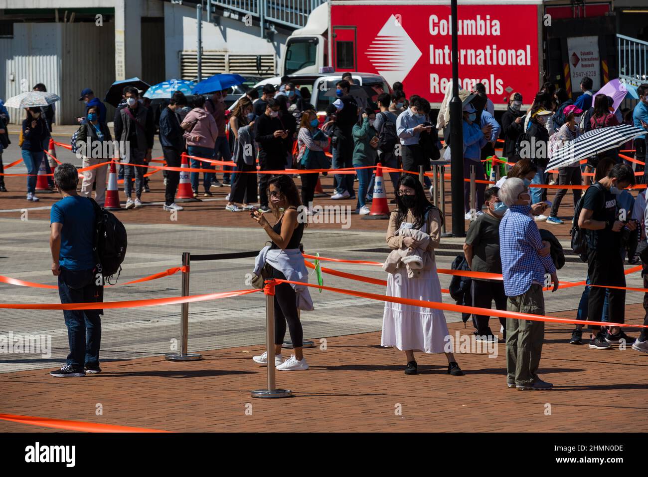Hong Kong, China. 11th Feb, 2022. People queue up r at an open air testing ground at Endinburgh Place in Central Hong Kong. Credit: Marc R. Fernandes /Alamy Live News Stock Photo