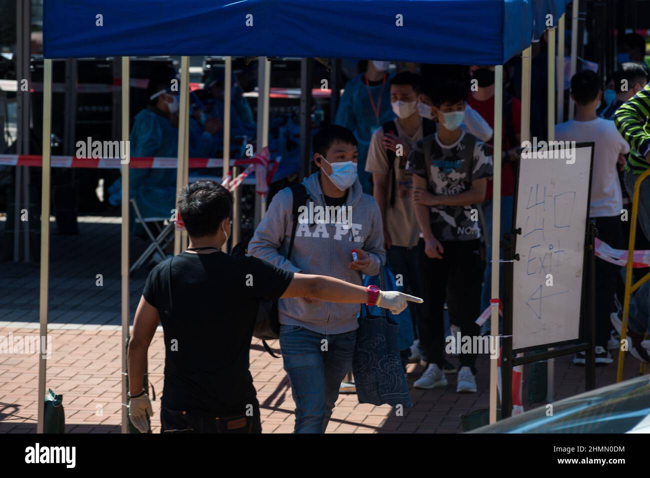 Hong Kong, China. 11th Feb, 2022. A man is directed towards a testing unit at a temporary COVID test centre in Edinburgh Place in Central Hong Kong. Credit: Marc R. Fernandes /Alamy Live News Stock Photo