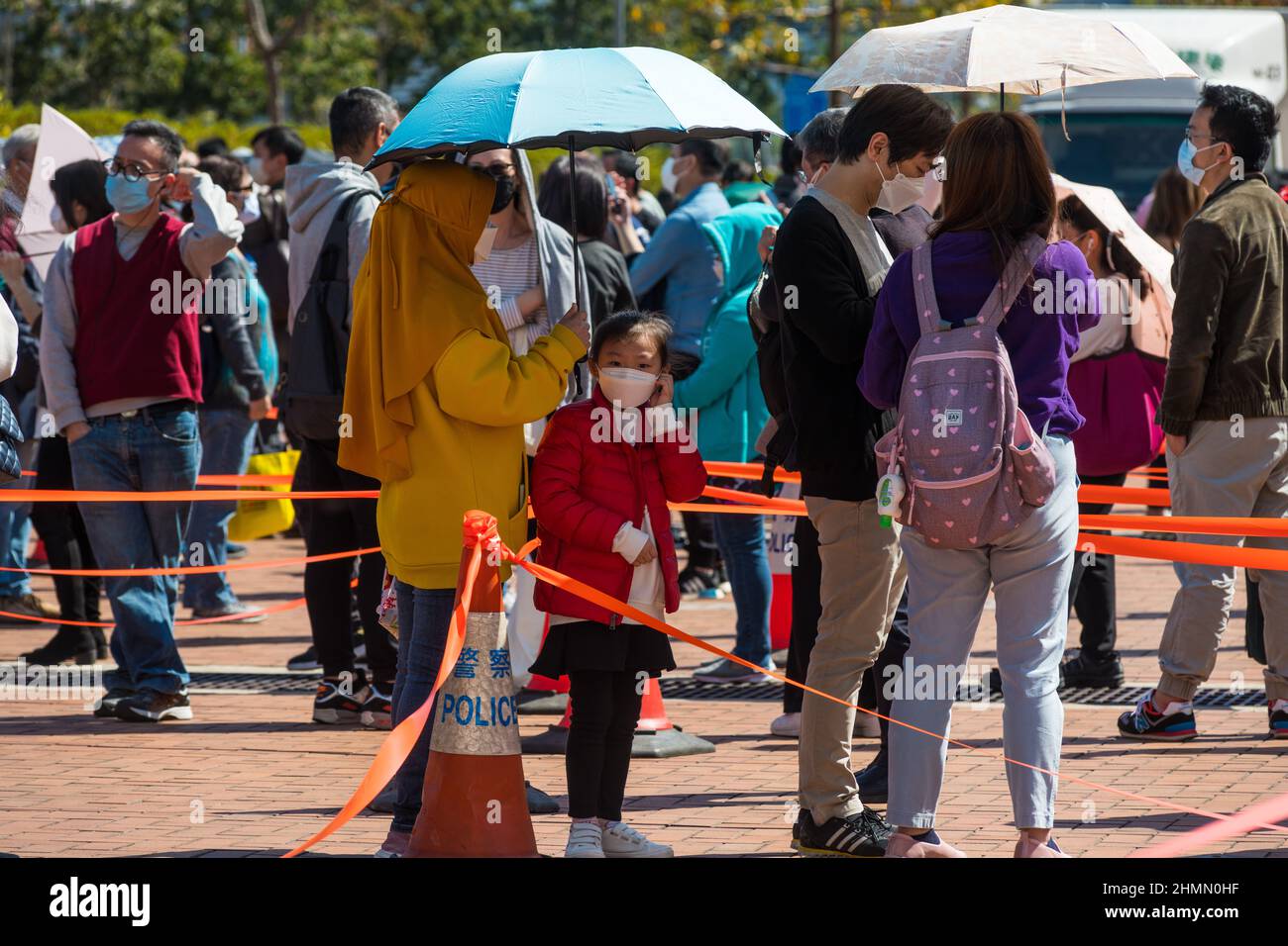 Hong Kong, China. 11th Feb, 2022. A domestic helper and the child she takes care of queue at a temporary COVID test centre in Edinburgh Place in Central Hong Kong. Many residents complained from having to gather with thousands of other people during an epidemic to take part in these mandatory tests. Credit: Marc R. Fernandes /Alamy Live News Stock Photo
