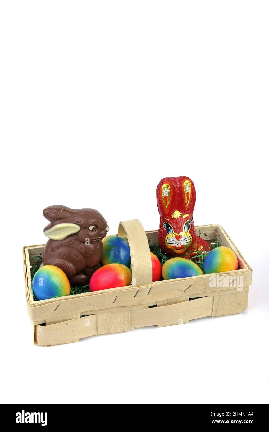 Easter basket with two chocolate Easter bunnies and dyed eggs Stock Photo