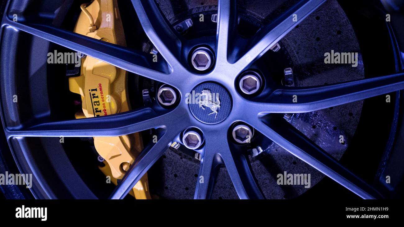 Modena, Italy - July 14, 2021: Light Alloy wheel, carbon-ceramic brake disc with yellow Brembo caliper Ferrari F12TDF Tour de France high-performance Stock Photo