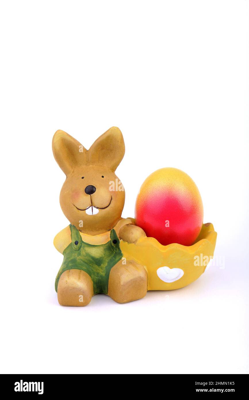 egg cup with Easter bunny and brightly colored Easter egg Stock Photo