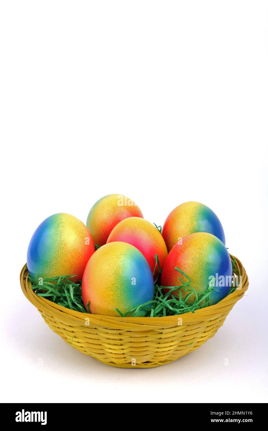 decorated brightly colored Easter eggs in a basket Stock Photo