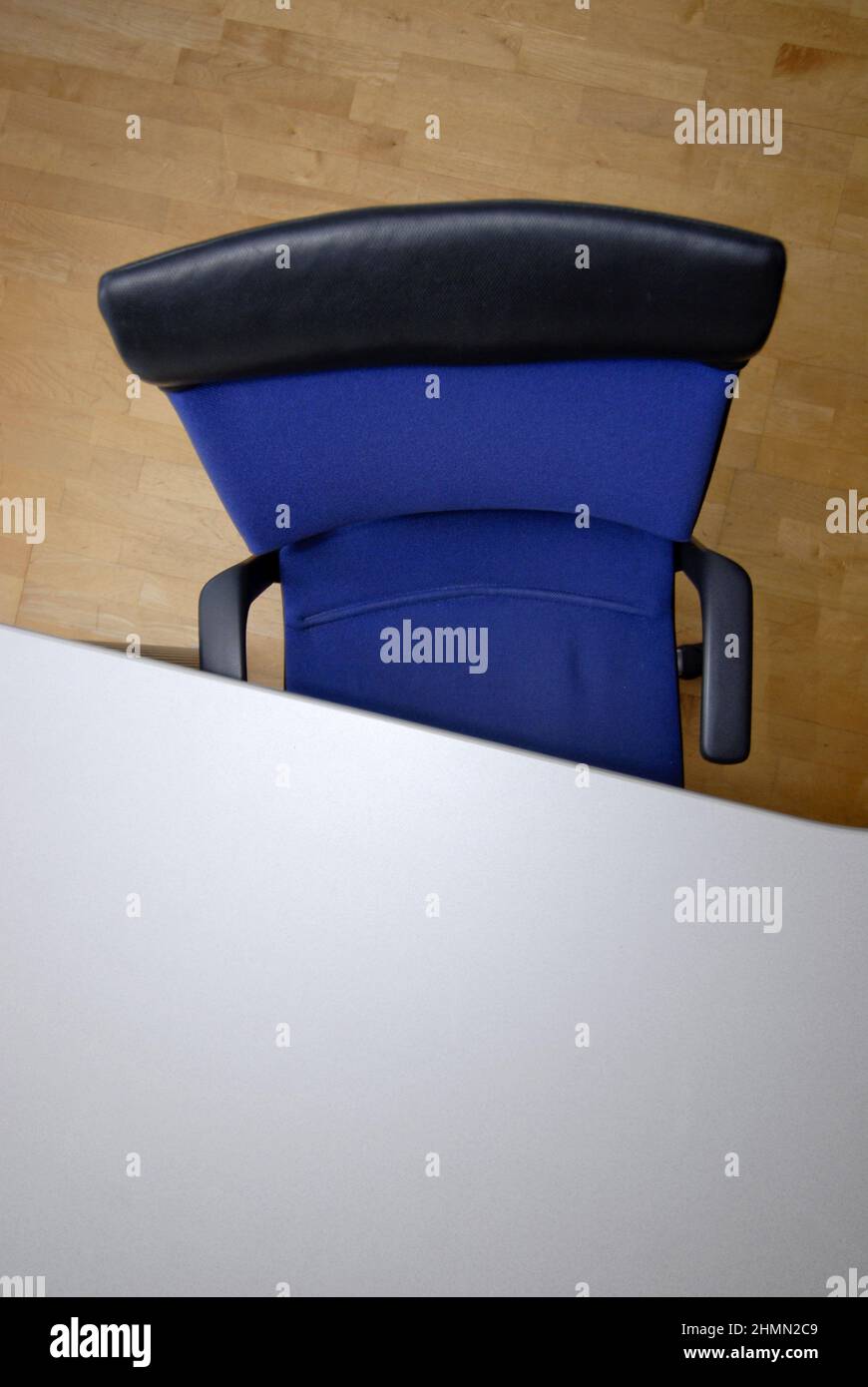 empty blue office chair at a writing desk Stock Photo