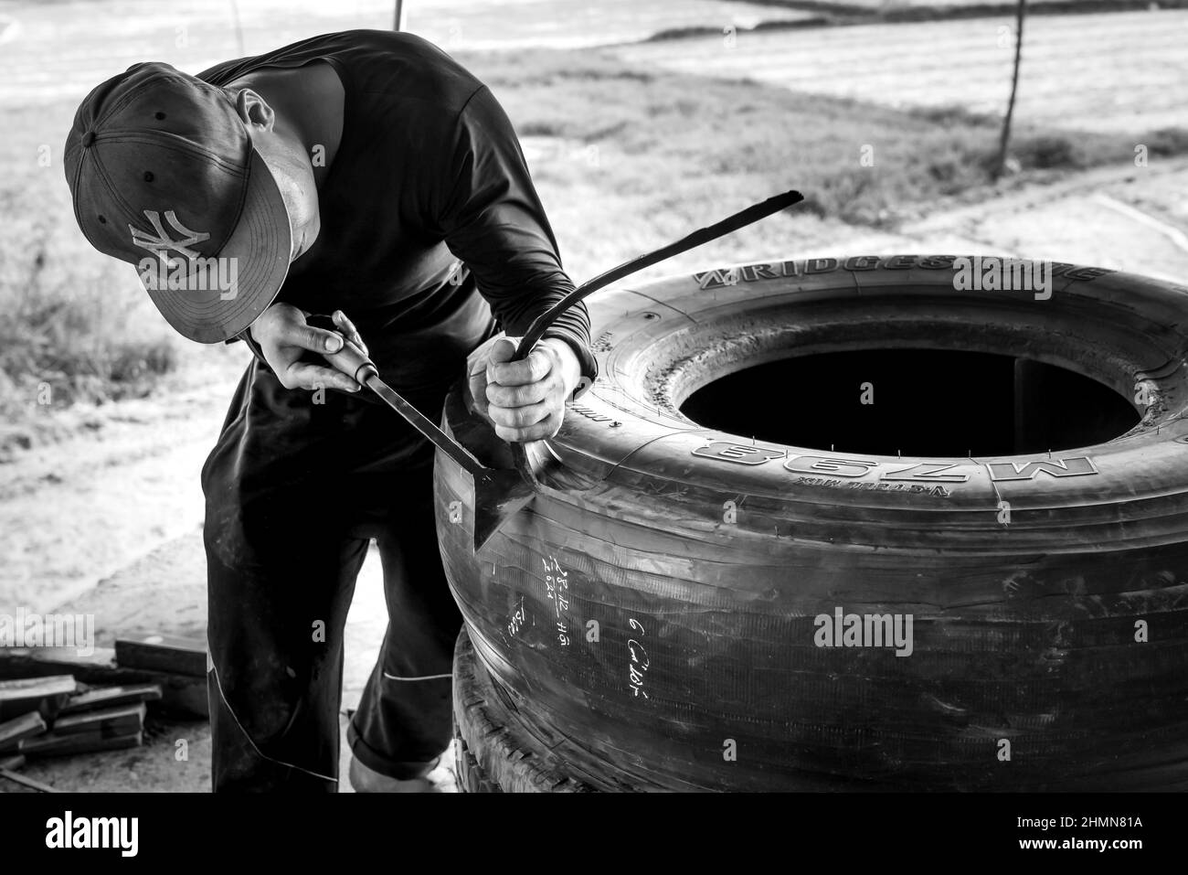 Son Tinh, Quang Ngai, Vietnam - December 31, 2021: workers work at an old car tire recycling factory in Son Tinh district, Quang Ngai province, Vietna Stock Photo