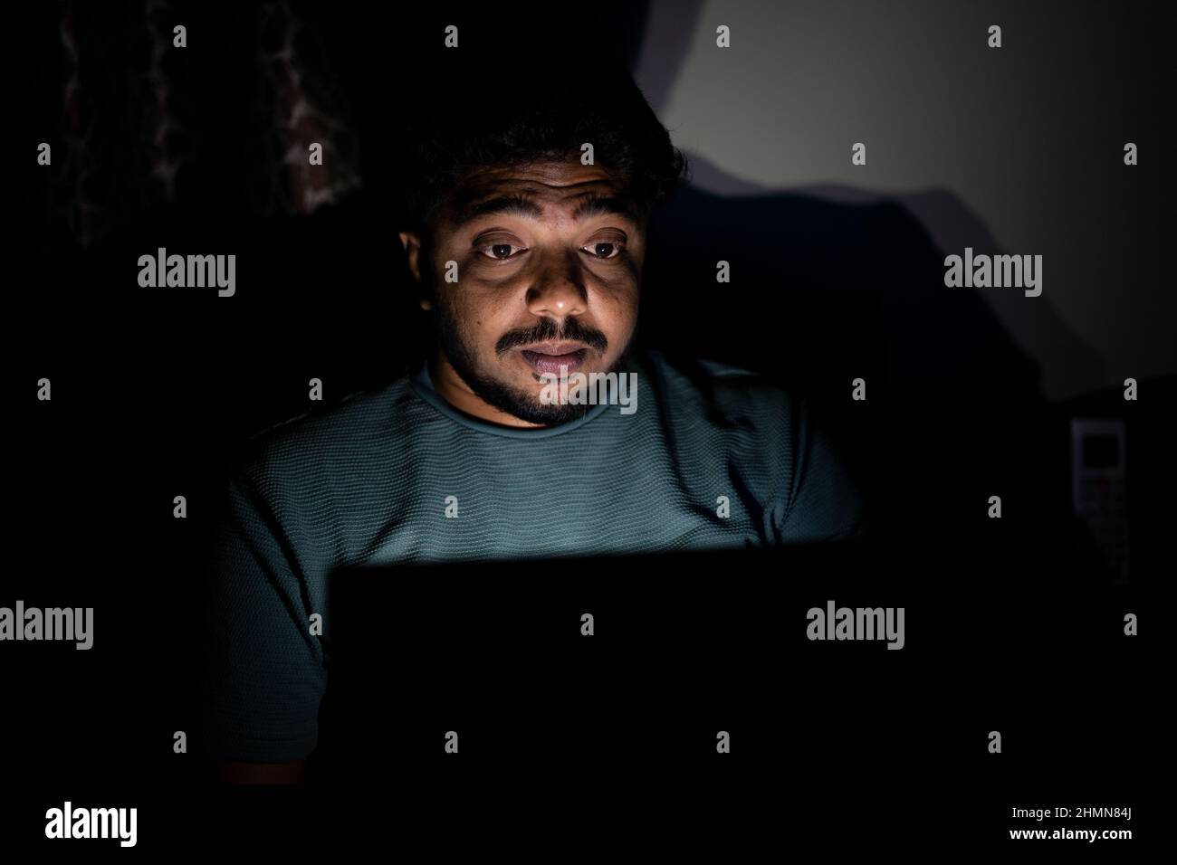 young corporate employee late night busy using laptop on bedroom - concept of overnight working, stressed out and work from home lifestyle Stock Photo