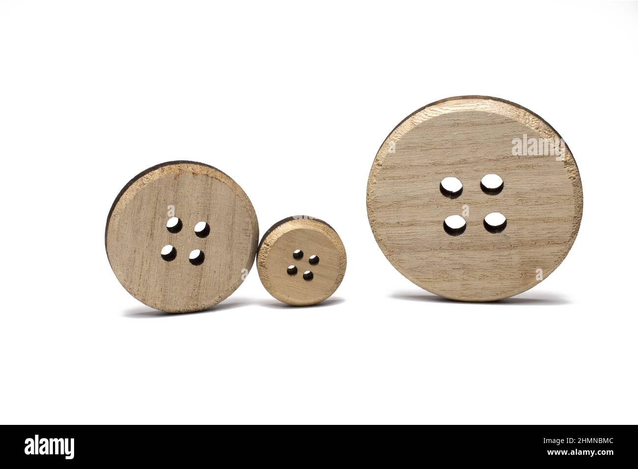 Close up of three different size wooden discs cut out from wooden