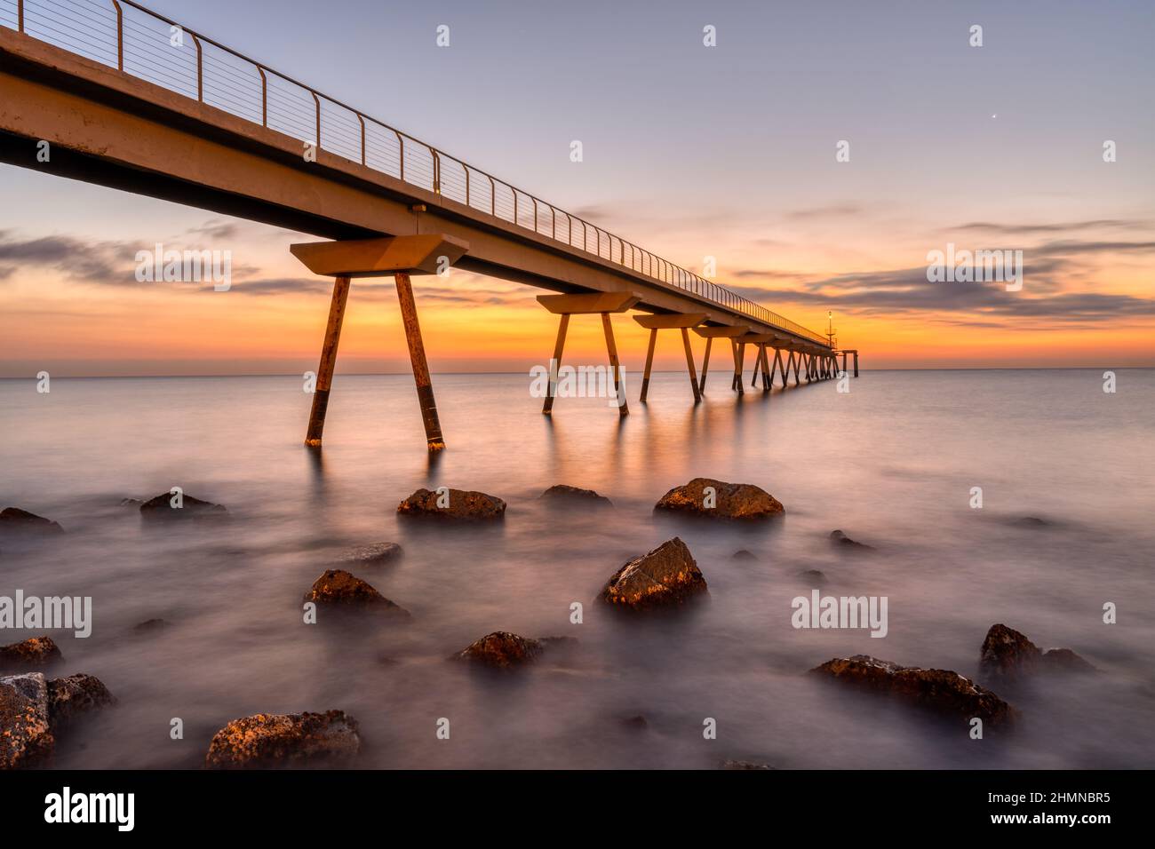 The sea pier of Badalona in Spain before sunrise Stock Photo