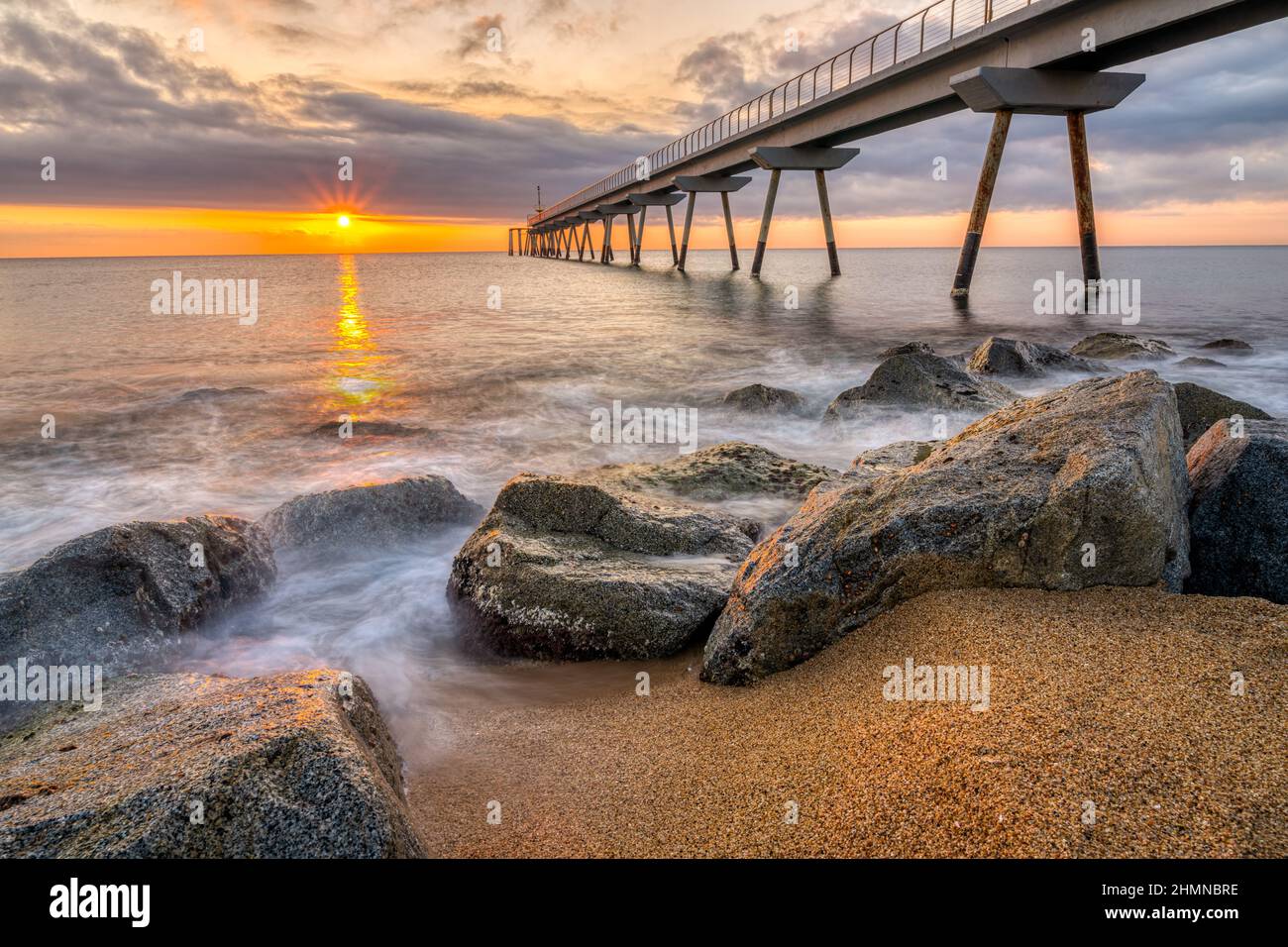The sea pier of Badalona in Spain at sunrise Stock Photo
