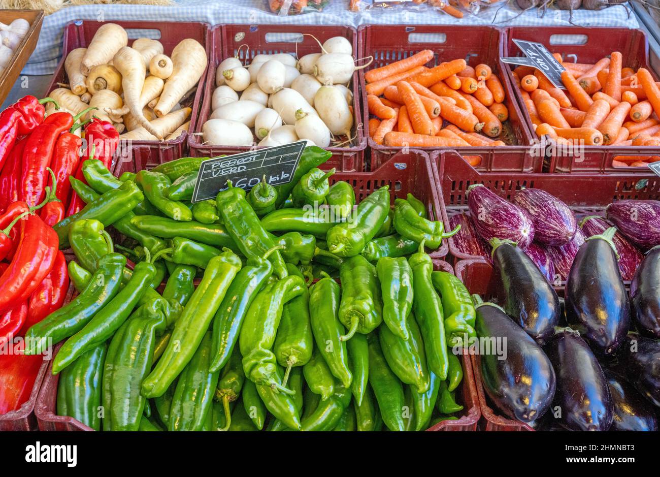 Different kinds of bell pepper and aubergines for sale at a market Stock Photo