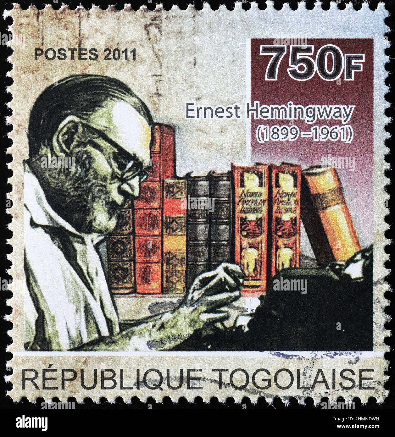 Ernest Hemingway at the typewriter on postage stamp Stock Photo
