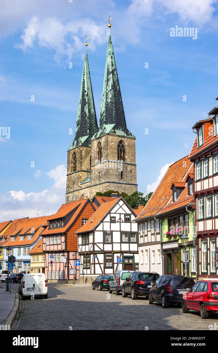 Quedlinburg, Saxony-Anhalt, Germany: Stationary traffic, historic, listed half-timbered houses in Pölkenstrasse and view of St. Nicholas Church. Stock Photo