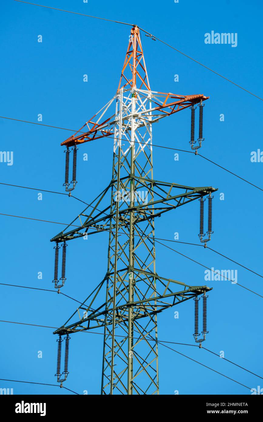 High voltage tower with electricity transmission power lines against ...