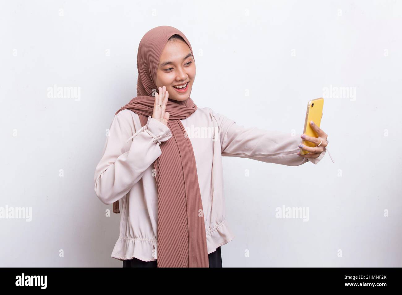 happy young asian beautiful muslim woman using mobile phone isolated on ...
