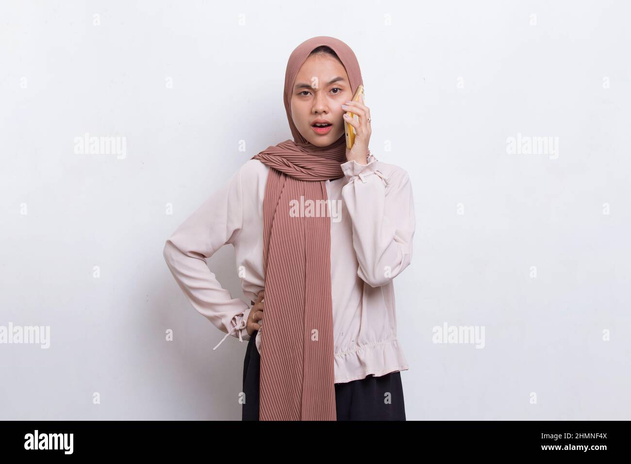 happy young asian beautiful muslim woman using mobile phone isolated on ...