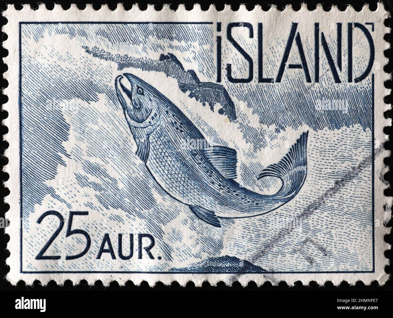 Salmon jumping upstream on vintage icelandic stamp Stock Photo