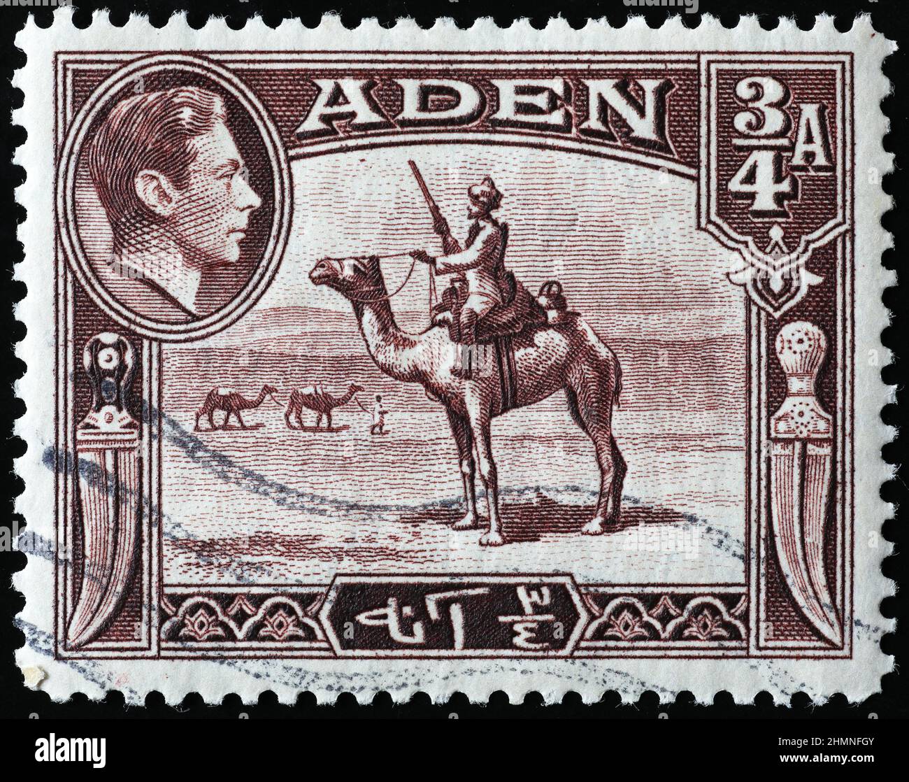 Soldier riding a dromedary on ancient stamp of Aden Stock Photo