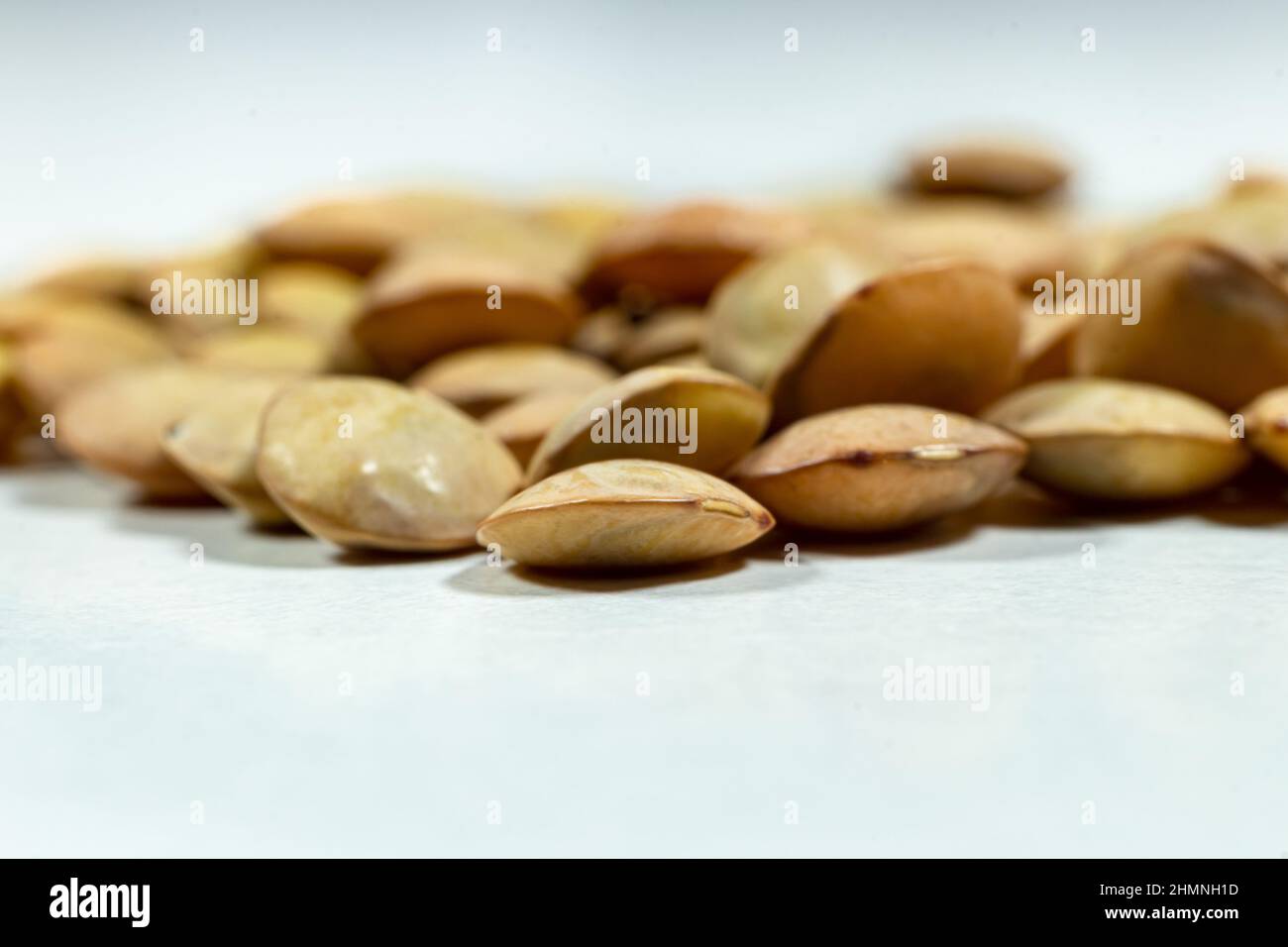 Isolated stack of uncooked lentils on white background - Dry beans - close-up - macro shoot. Stock Photo