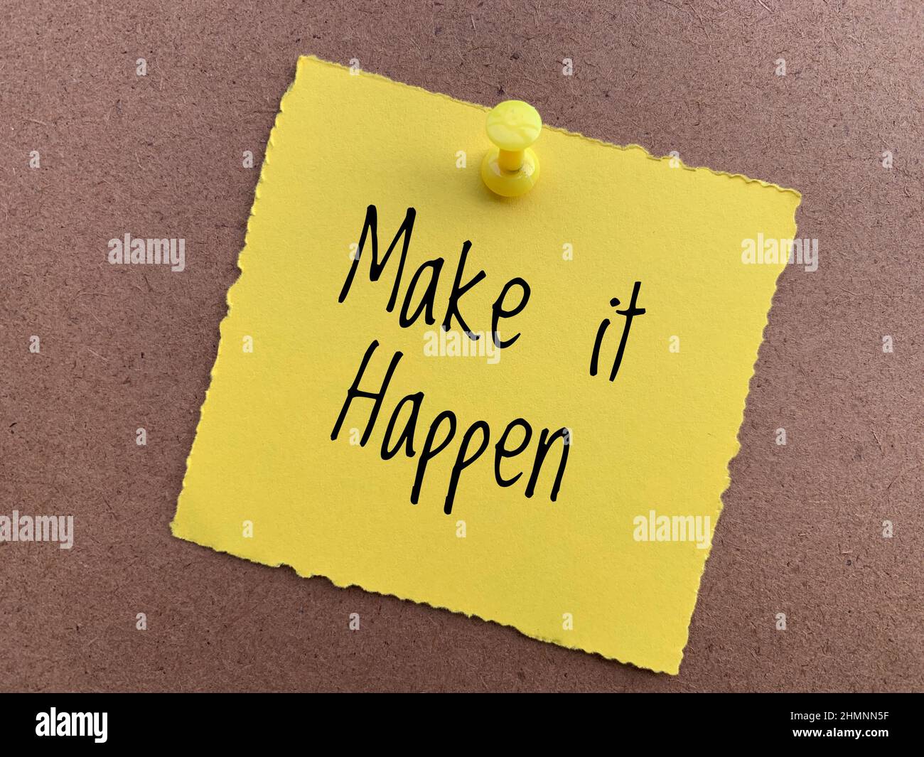 Make it happen text on yellow sticky note. Conceptual. Stock Photo