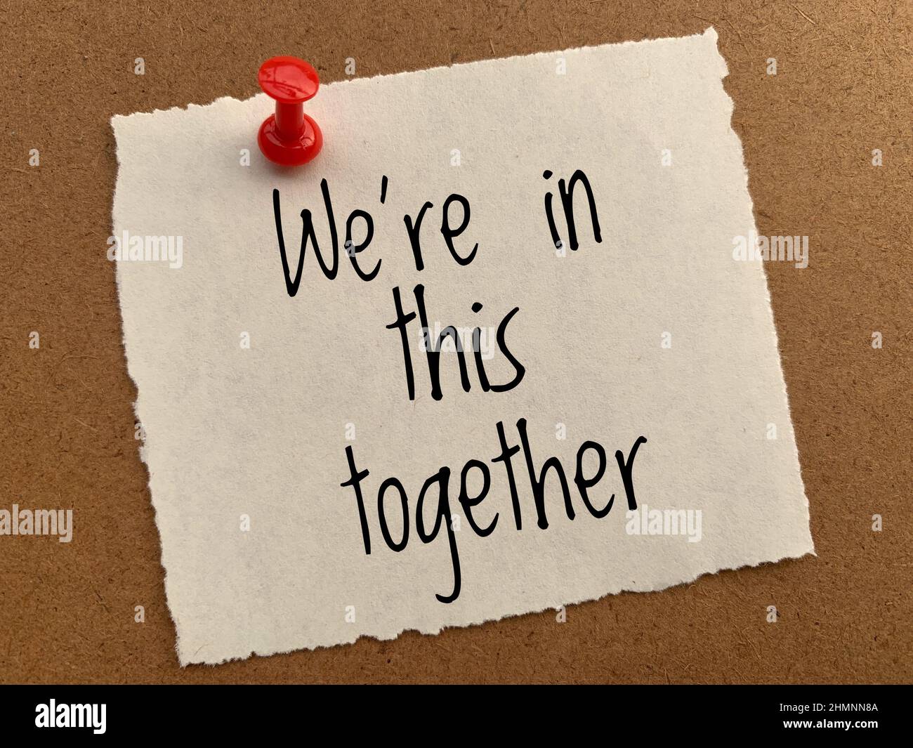 We are in this together text on yellow torn notepad. Conceptual Stock ...
