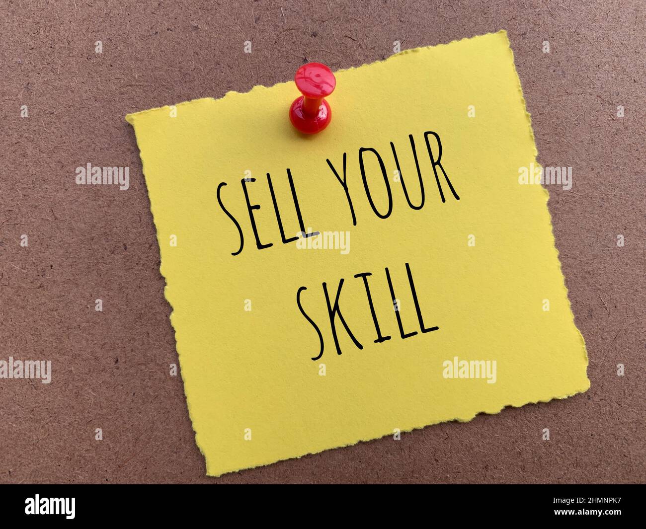 Sell your skill text on yellow torn notepad Stock Photo