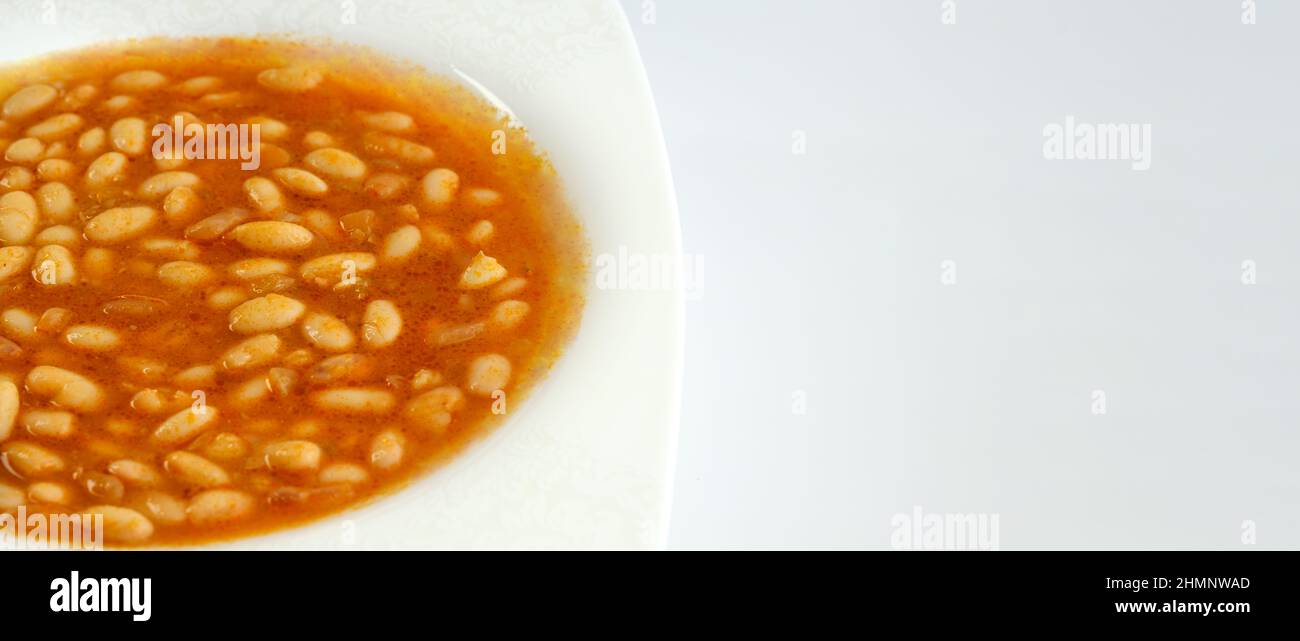 Traditional Turkish food: Kuru Fasulye or Haricot Bean isolated on white background. Plate of popular traditional food of Turkey and Middle East. Stock Photo