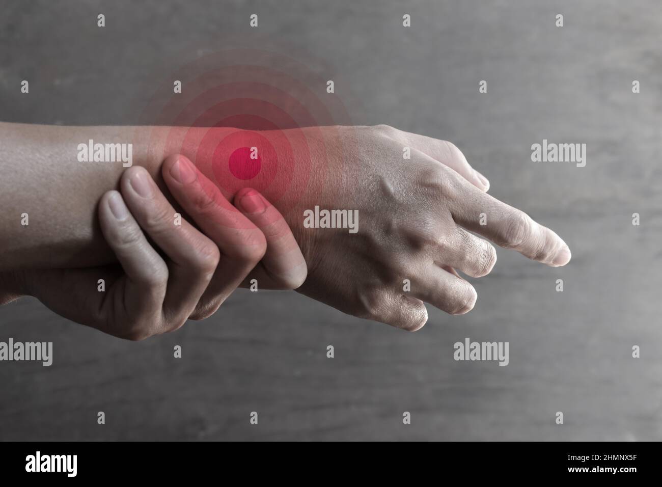 Inflammation of Asian young man wrist joint and hand. Concept of joint pain and hand problems