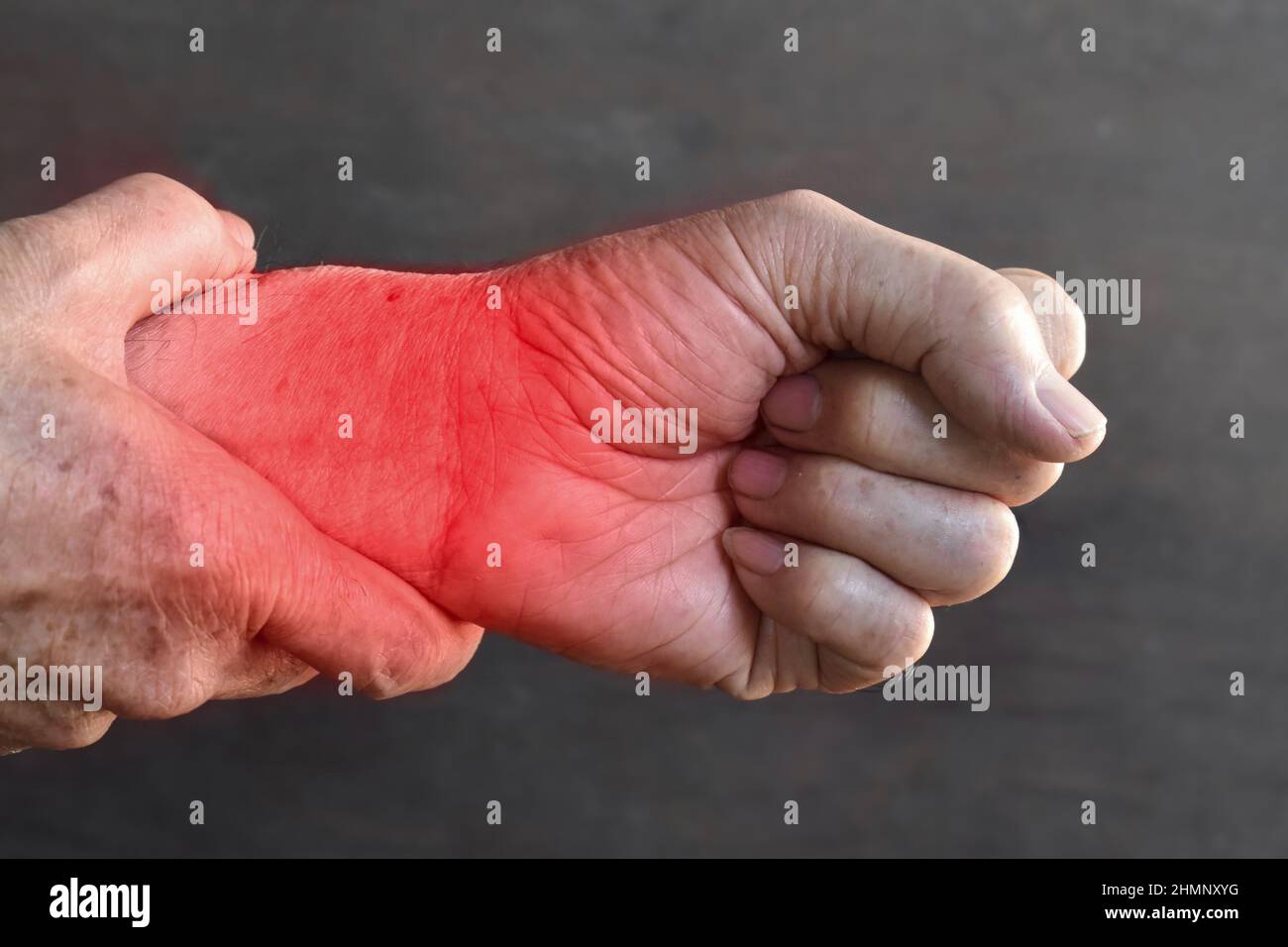 Pain in the wrist joint of Southeast Asian elder man. Concept of hand