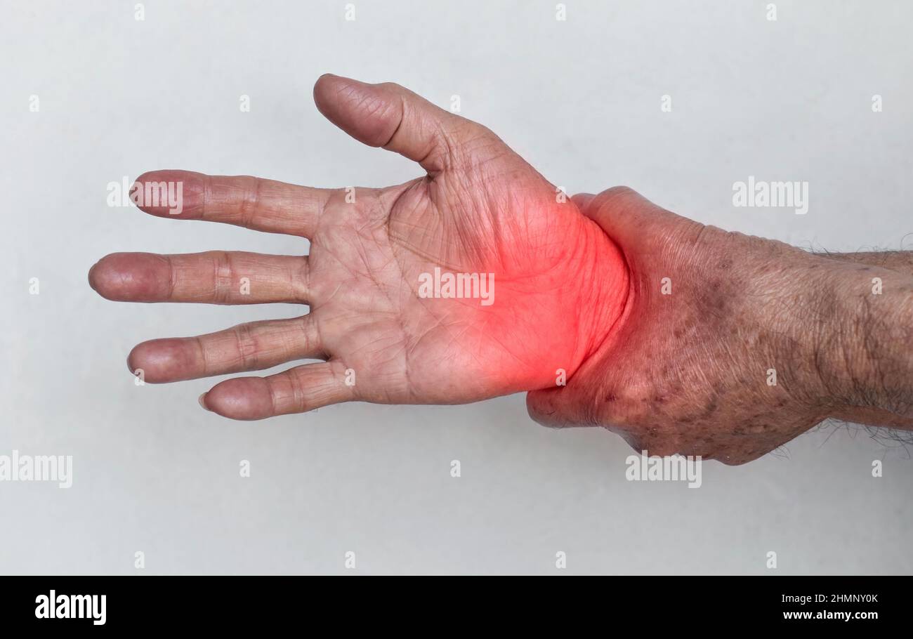 Pain in the wrist joint of Southeast Asian elder man. Concept of hand