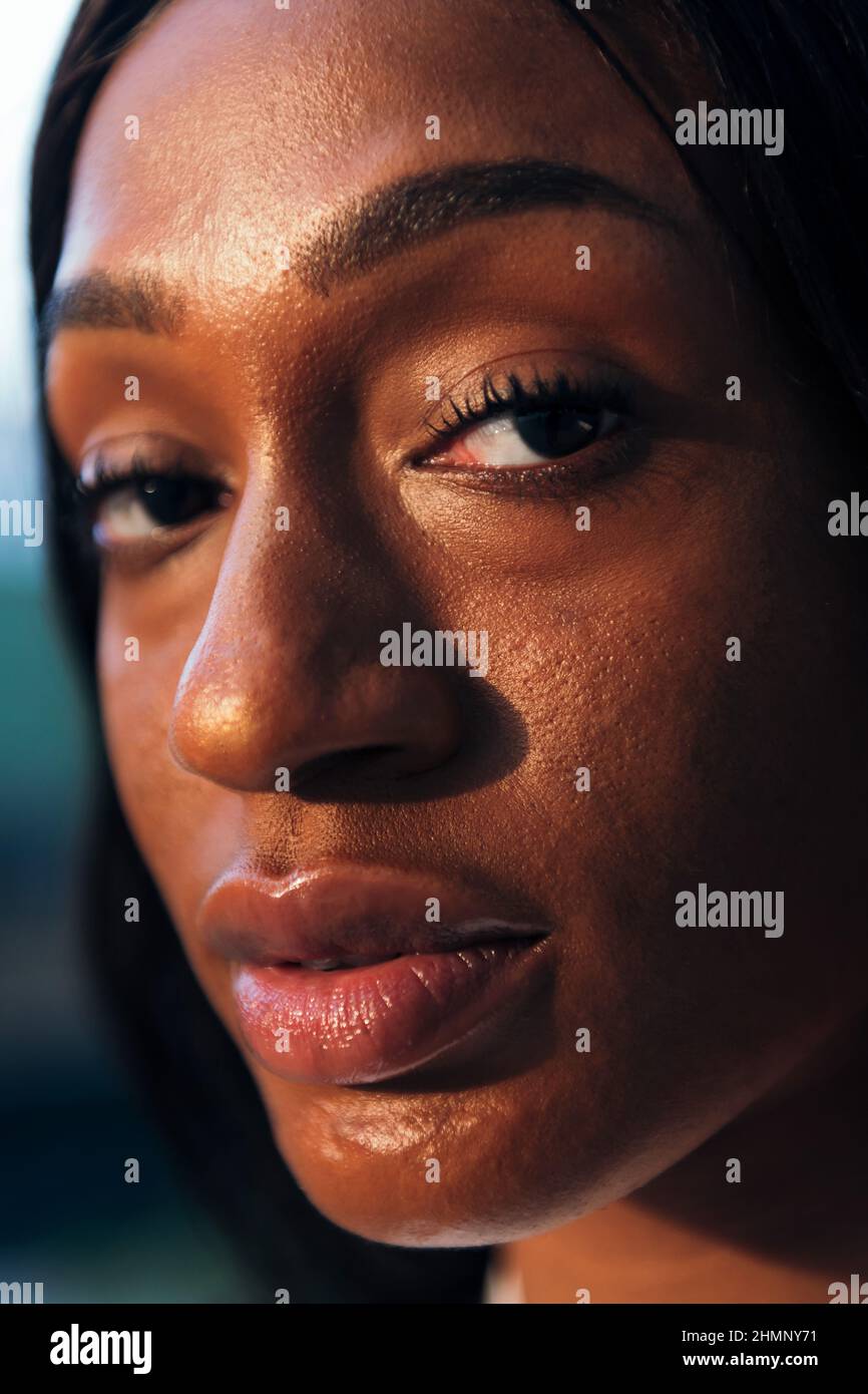 vertical close-up portrait of a young african woman in profile, concept ...