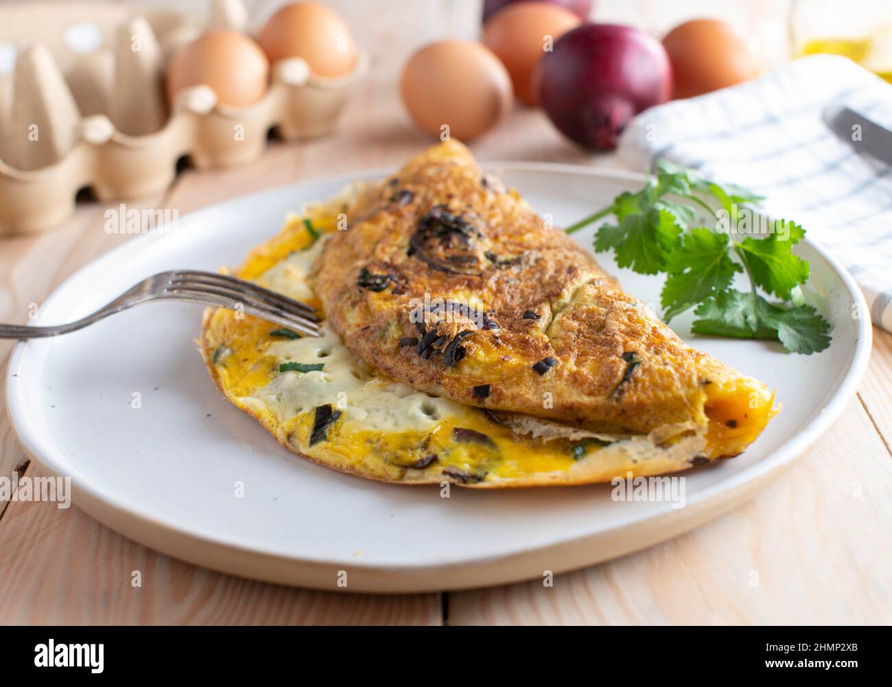 Omelette or omelet with roasted red onions, chives and cheese, Low carb or ketogenic meal Stock Photo