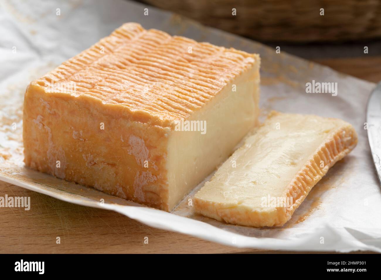 Limburger or Herve cheese and slice with a strong smell on package paper Stock Photo