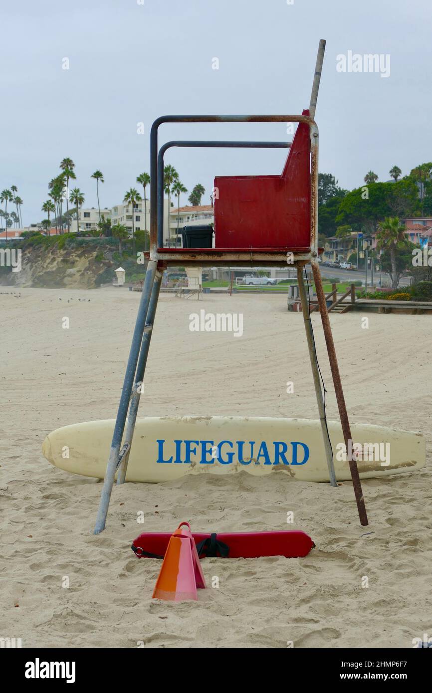 red lifeguard chair, swim fins and floatation device at the ready Stock Photo