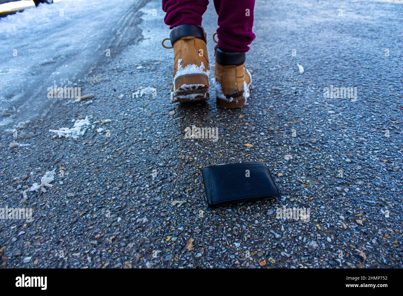 Man dropping his wallet on the road. Concept of losing wallet. Stock Photo