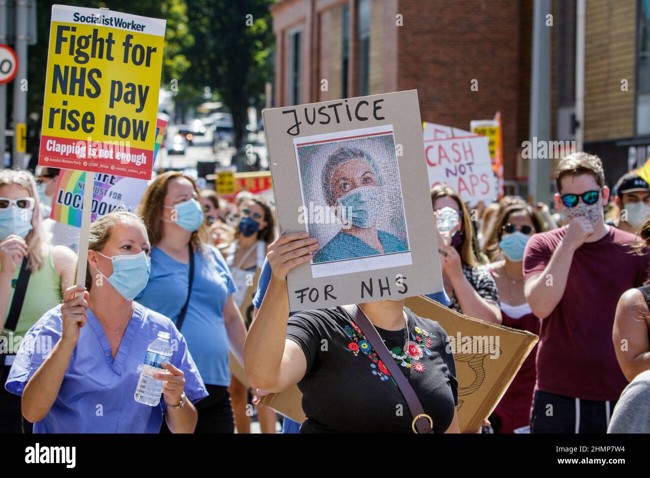 Placard carrying protesters are pictured as they take part in an NHS workers ‘pay justice’ demonstration and protest march in Bristol, 8th August 2020 Stock Photo