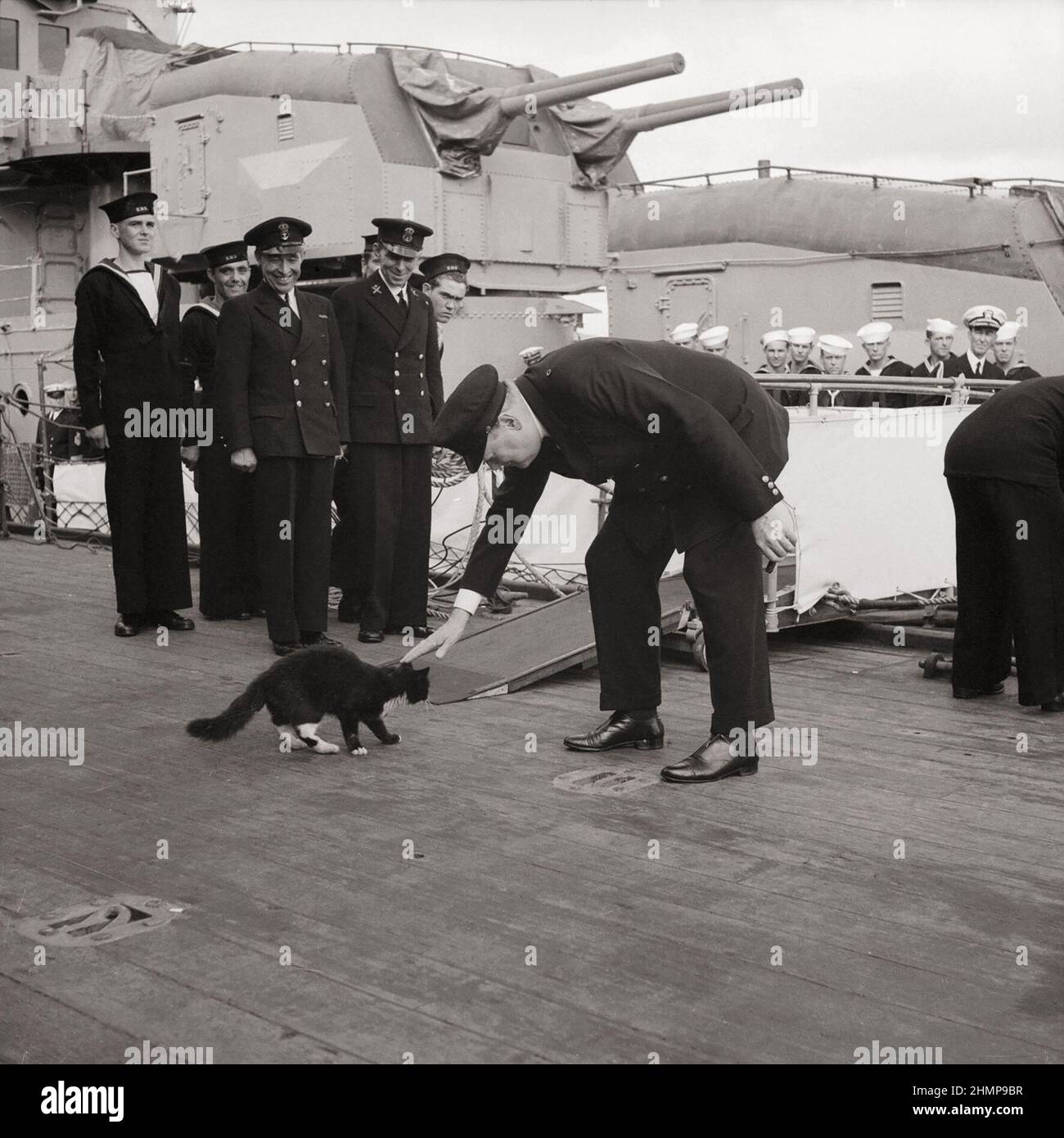 Winston Churchill stops 'Blackie', ship's cat of HMS PRINCE OF WALES, crossing over to a US destroyer during the Atlantic Conference, August 1941. Stock Photo