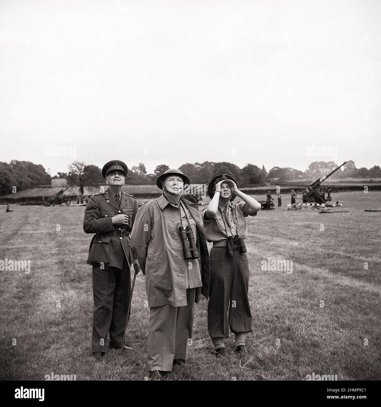 Winston Churchill with his daughter Mary and General Sir Frederick Pile (GOC Anti-Aircraft Command) watch anti-aircraft guns in action. 1944. Stock Photo