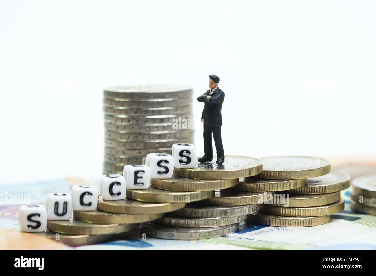 a manager stands on top of a coin tower, the ascent is described with ...