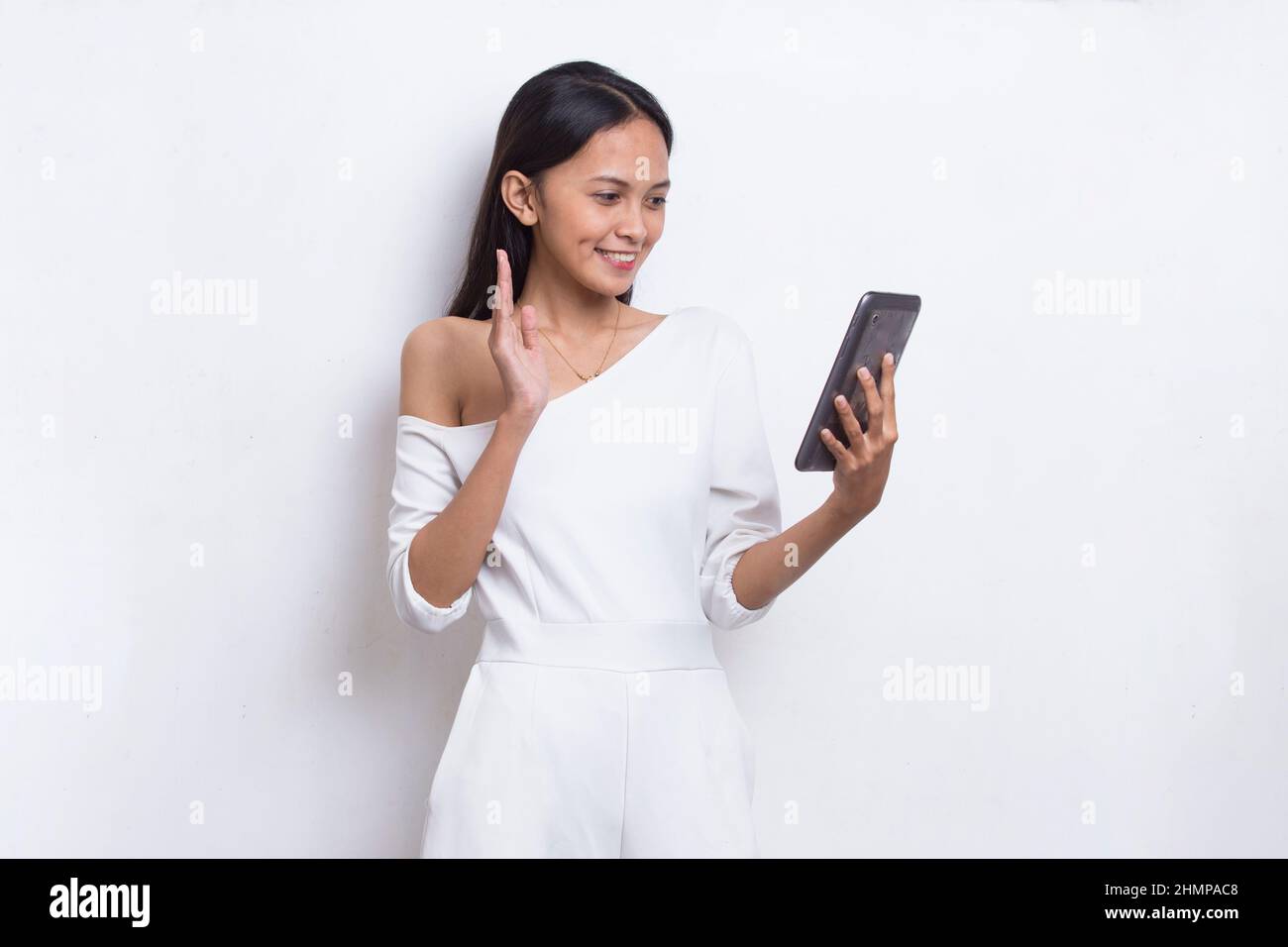 happy young asian beautiful woman using mobile phone isolated on white ...