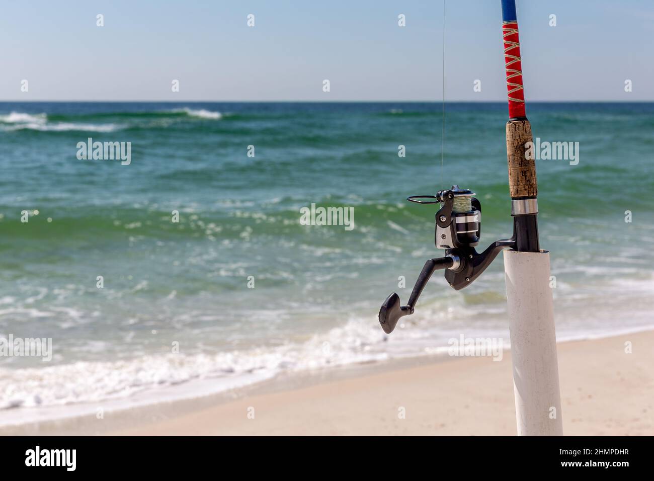 Surf fishing pole in a holder at the shore. Close up view with copy space  if needed. Concepts could include fishing, travel, relaxation, leisure  Stock Photo - Alamy