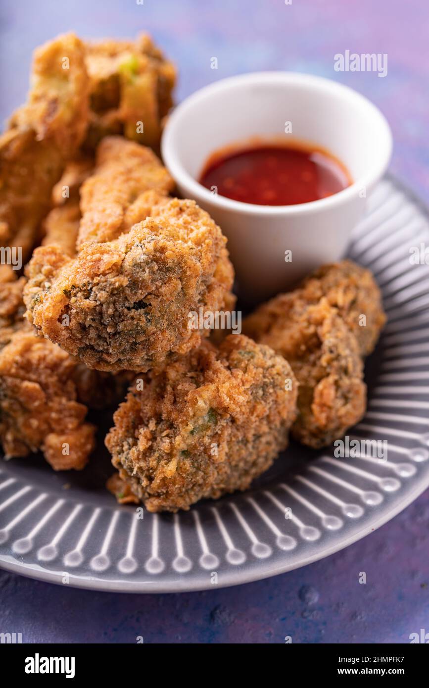 Asian fusion vegan meatfree meal of battered fried broccoli with sweet