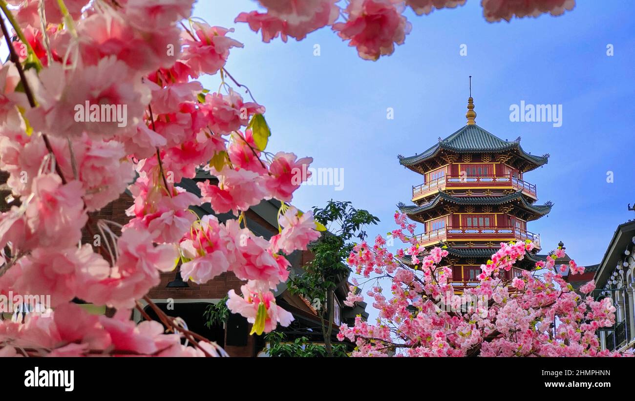 Pagoda through cherry blossom flowers, Indonesia Stock Photo